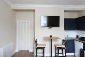 a kitchen with a table and two chairs and a tv at Town View in Stourport