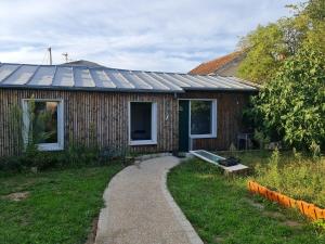 a wooden house with a path leading to it at Dépendance-Appartement dans maison à Montgeron in Montgeron
