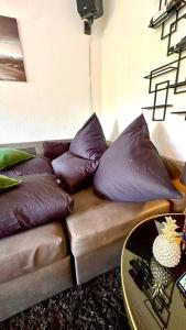 a living room with a couch with pillows and a table at Luxury apartment near Oktoberfest in Munich
