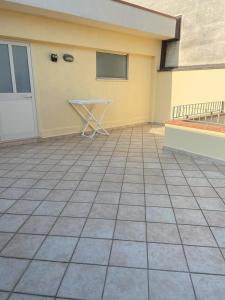 a patio with a table in front of a building at Casa Vacanze - Oliveri - Sicilia in Oliveri