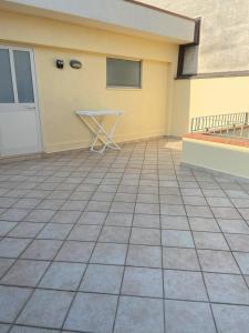 a patio with a table in front of a building at Casa Vacanze - Oliveri - Sicilia in Oliveri +2 photos
