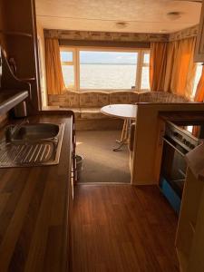 a kitchen with a sink and a table in a rv at Retro house in nature in Šamorín