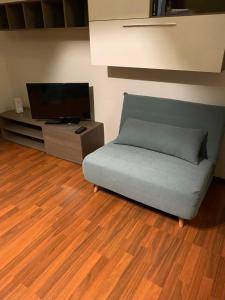 a living room with a couch and a flat screen tv at Gabe in Cesena +6 photos