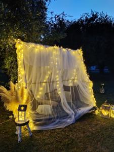 a tent with lights in a yard at night at Il rifugio tra gli ulivi in Ortona
