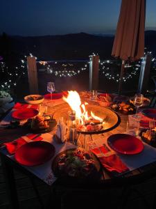 a table with plates of food and a fire on it at Vysche Neba in Bukovel