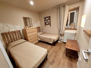 a small room with two beds and a table at Le finestre sul lago in Piediluco