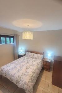 a bedroom with a bed and two night stands at Brigadoon 3 bed Apartment with Stunning valley Veiws in Roundwood