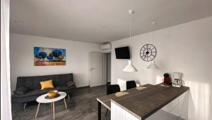 a living room with a couch and a table at Apartment Lantana Hvar in Hvar