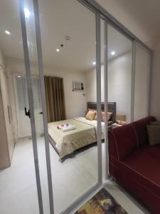 a bedroom with a bed and a sliding glass door at Family-Friendly Condo Units at Matina Enclaves in Davao City
