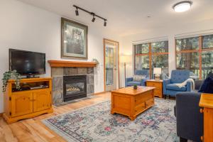a living room with a tv and a fireplace at Steps From The Village with Pool and Hot Tub by Harmony Whistler in Whistler