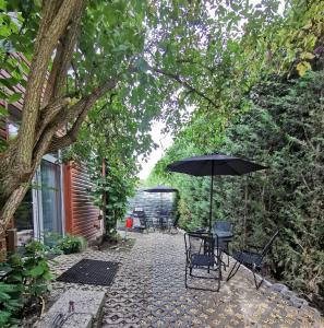 a patio with a table and an umbrella at Stern in Hückelhoven