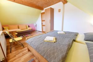 a small room with a bed and a couch at Holiday Home Vukovic in Saborsko