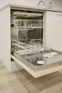 a dishwasher with white dishes inside of it at Ferienwohnung Endingen am Kaiserstuhl in Endingen