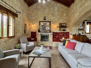 - un salon avec un canapé et une cheminée dans l'établissement Villa Toula with pool Nr Armeni Crete, à Makhairoí