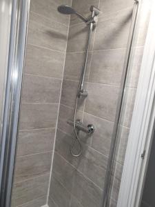 a shower with a glass door in a bathroom at Affordable rooms in Gillingham in Gillingham