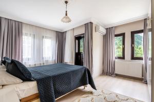 um quarto com uma cama com um cobertor azul em Amazing City House Next to Sea in Heart of Trabzon em Arsin