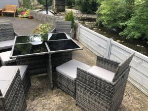 a patio with a table and chairs and a fence at Labernum Cottage, Ingleton, Yorkshire Dales National Park 3 Peaks and Near the Lake District, Pet Friendly in Ingleton