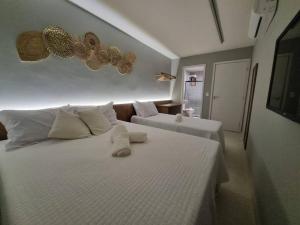 a bedroom with a large white bed with white pillows at Kanui Milagres 112 in São Miguel dos Milagres +28 photos