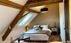 a bedroom with a large bed in a attic at Le Gîte de la Grange in La Wantzenau