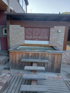 a kiosk with benches in front of a building at LaGaressina suite Anna - Jacuzzi & Spa in Garessio