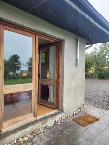 a house with a sliding glass door on the side at Brigadoon lakeview room in Roundwood