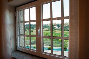 a room with a large window with a view at Casinha do Sabugueiro in Ponte de Lima