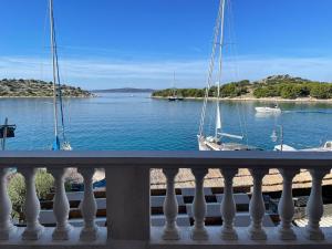 a balcony with a view of a body of water with boats at Apartman Roko in Tribunj