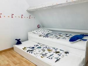 Ein Bett oder Betten in einem Zimmer der Unterkunft Le Gîte du Phare vue sur mer