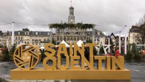 a large sign that says san python in front of a city at Richelieu 2 chez Adrien in Saint-Quentin