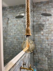 a bathroom with a glass light hanging over a sink at Aquí Ahora San José in San José