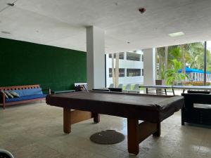 a pool table in a room with a green wall at Sunny Isles Miami HOLIDAY apartment in Miami Beach