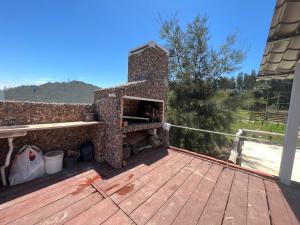 a brick oven sitting on top of a deck at Casa shalet completa para 6 personas in Bella Vista