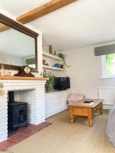 a living room with a fireplace and a table at The Town House in Aylsham