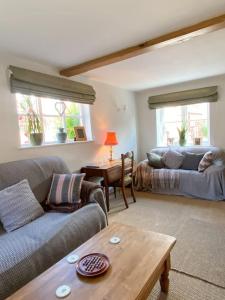 ein Wohnzimmer mit 2 Sofas und einem Tisch in der Unterkunft The Town House in Aylsham