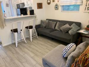 a living room with a couch and two chairs at Little Covington Home in Covington