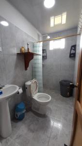 a bathroom with a toilet and a sink at Apto Hogar Dulce Hogar ARBOLETES in Arboletes