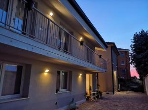 a apartment building with a balcony and a patio at La Diletta - Camere di Charme in Verona