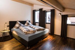 a bedroom with a bed with two pillows on it at N6 Oberstdorf in Oberstdorf