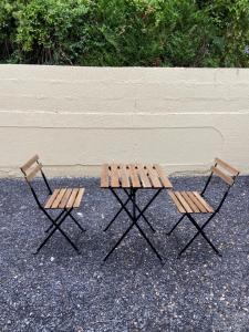 twee stoelen naast een houten picknicktafel bij La galerie, proche aéroport in Tillé