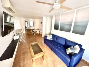 un soggiorno con divano blu e tavolo di Marina Zahara a Zahara de los Atunes