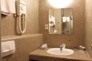 a bathroom with a sink and a mirror at Steichele Hotel & Weinrestaurant in Nuremberg +54 photos