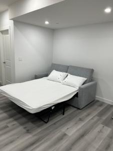 a bed in a room with a white mattress at Newly built one bedroom 2 bed in Calgary