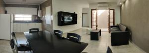 - un salon avec une table et une télévision murale dans l'établissement Altos de Mitre, à Reconquista