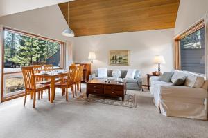 a living room with a couch and a table at 26 Mountain View Lodge - Meredith Lodging in Bend