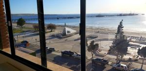 a view of a parking lot from a window at Amar el mar in Puerto Madryn