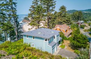 an aerial view of a blue house on a hill at Neskowin Lookout in Neskowin