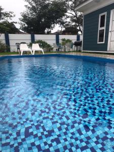 a swimming pool with blue and white tiles on it at lot 1217 large private villa with pool A’Famosa golf resort melayu in Kampong Alor Gajah