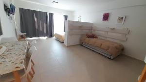 a living room with a couch and a table at Amplio Estudio de lujo con balcon y parrilla in Puerto Madryn