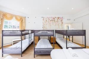 a room with four bunk beds in it at Larger Groups Apartment with Garden and Parking in London