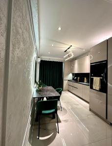 a kitchen and dining room with a table and chairs at Luxury City-Centric Apartment for Booking in Chişinău